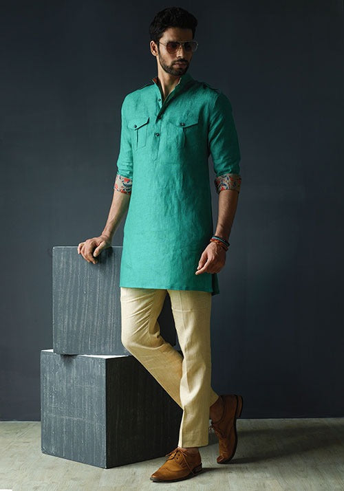 PATHANI GREEN LINEN SHORT KURTA WITH PRINTED REVERSE CUFF AND BEIGE PANTS.